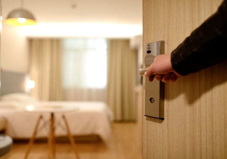 Hand opening modern hotel room door