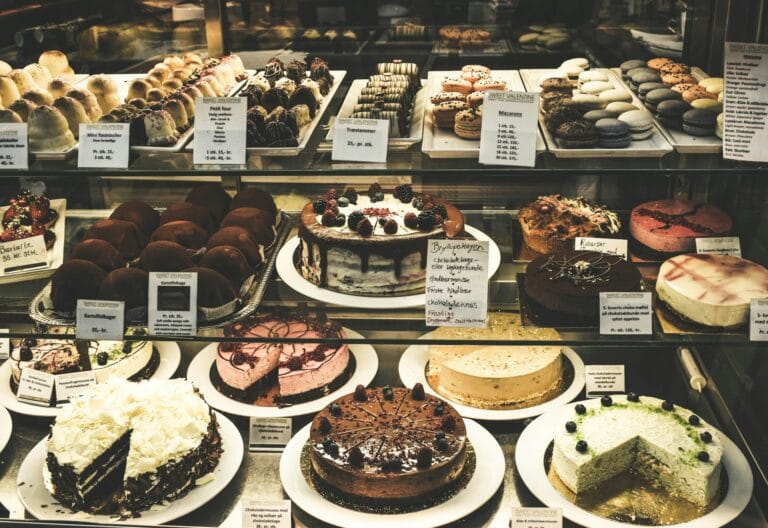 Assorted desserts displayed in a bakery window