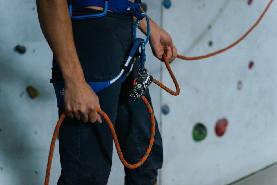 Alpiniste ajustant son équipement de sécurité en salle