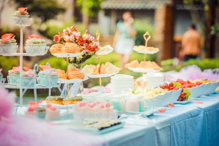 Outdoor buffet with desserts and fruit.