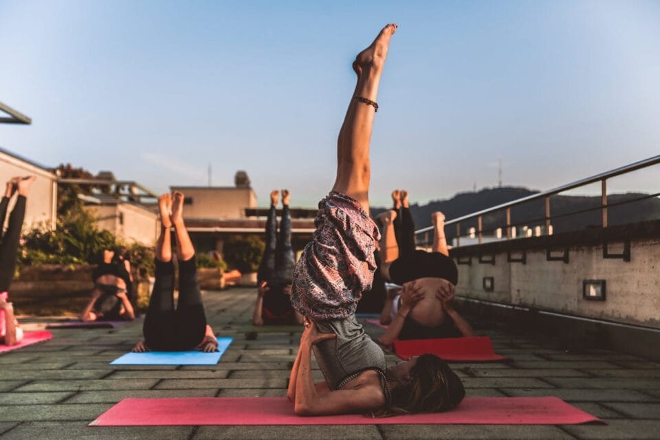 Outdoor yoga class during sunset on rooftop